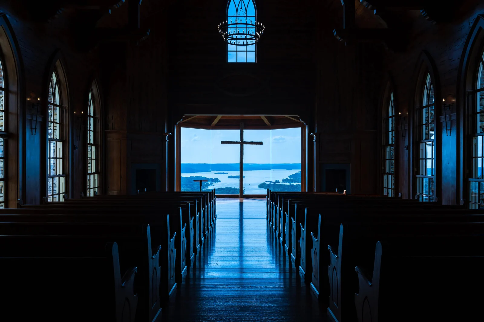 A church interior with a cross framed in the open doorway