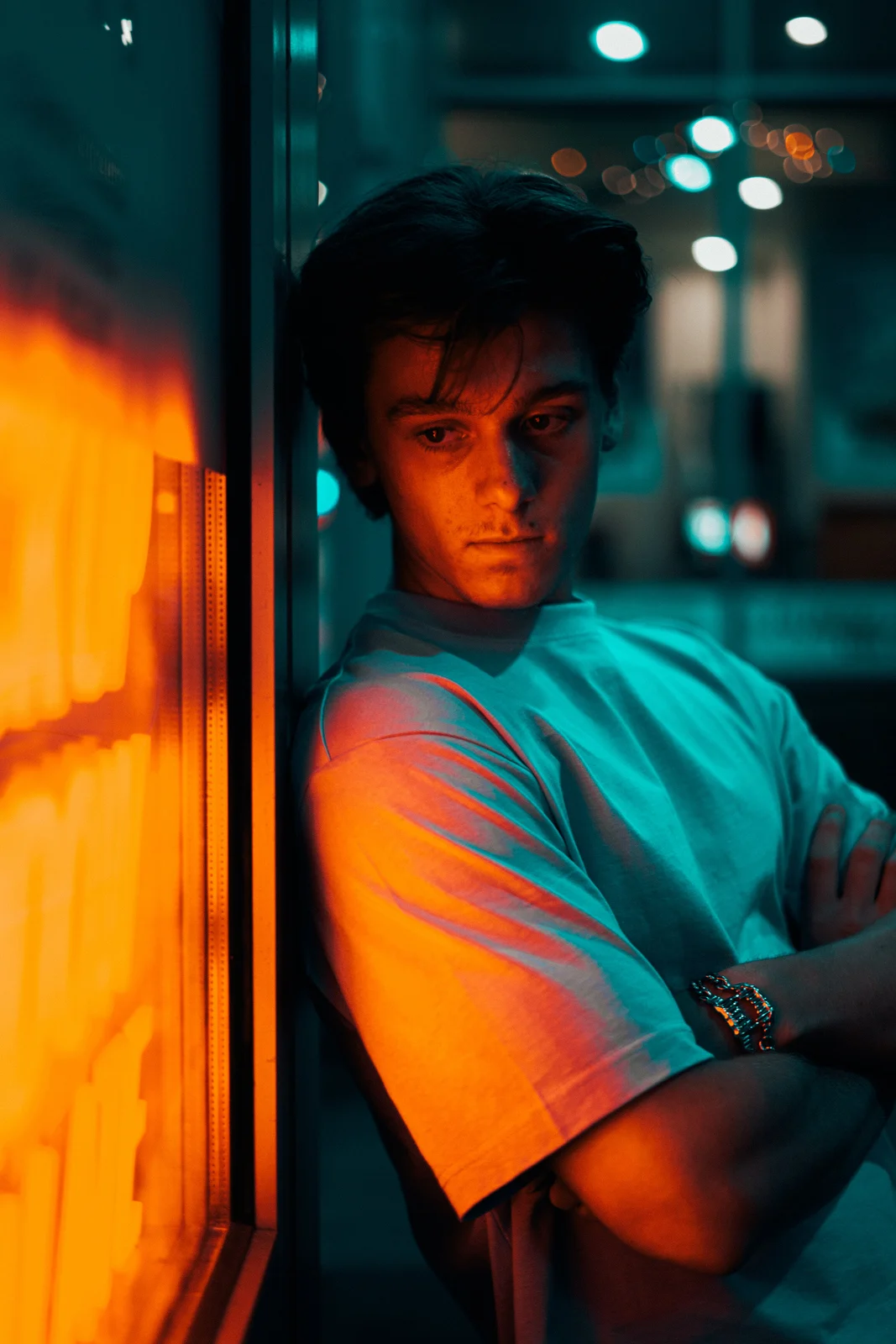 A cinematic portrait lit in orange and blue
