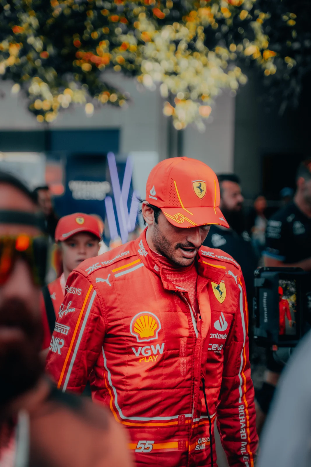 Ferrari driver moving through a crowd