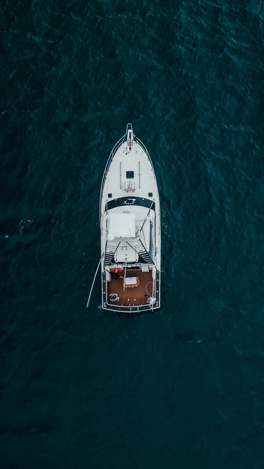 A boat seen from above in deep blue water