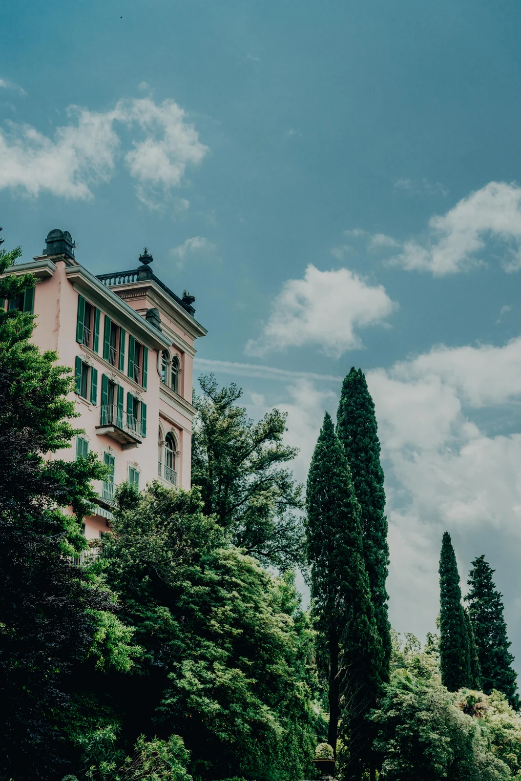 Italian villa and cypress trees under clouds